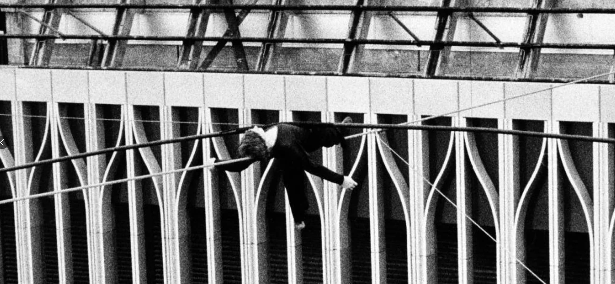 man on wire lying down - Nn >